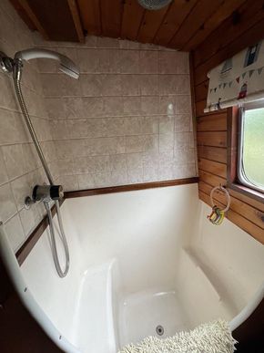 Sit in shower tray. 