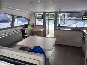 Modern interior of 2021 Leopard 40 catamaran with dining area and kitchen.