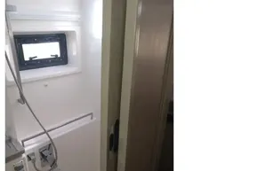 Compact bathroom in a 2018 Leopard 45 yacht, featuring a shower and window.