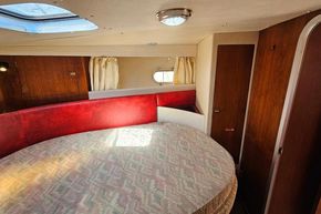 Interior of 1989 Princess 35 Flybridge yacht with round bed and skylight.
