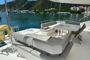 Luxurious 2022 Leopard 53 Powercat yacht with spacious outdoor seating and scenic marina view.
