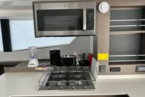 Modern kitchen in 2022 Leopard 53 Powercat with microwave, stove, and appliances.