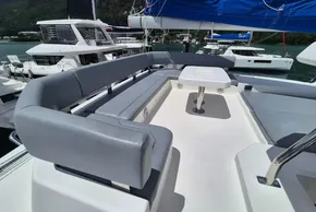 Luxurious seating area on a 2021 Leopard 45 catamaran, docked at a marina.