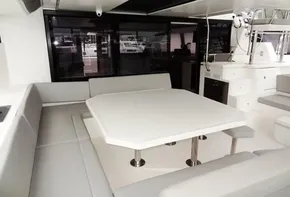 Modern dining area on a 2020 Leopard 50 yacht with white table and gray seating.