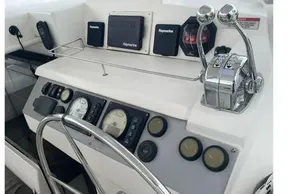 Control panel of a 2020 Leopard 40 yacht with navigation instruments and throttle levers.