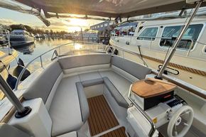 Luxurious 2015 Alfastreet 23 boat interior with elegant seating at sunset in marina.