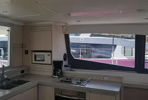 Modern kitchen interior of a 2017 Leopard 48 catamaran with large windows.