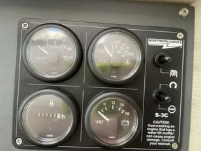 Control panel of a 2020 Leopard 50 boat with gauges and warning labels.