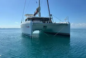 2022 Leopard 42 catamaran on calm blue water under clear sky.