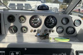 Control panel of a 1991 Sealine 290 Ambassador boat with gauges and keys.