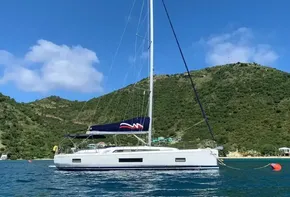2020 Beneteau Oceanis 46.1 sailboat anchored in a scenic bay.