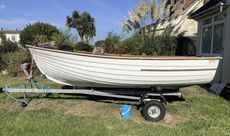 Clinker style dinghy rowing boat with trailer