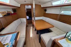 Interior of 2020 Jeanneau Sun Odyssey 389 sailboat with cozy seating and wooden table.