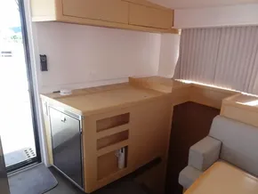 Modern kitchen area in a 2020 Lagoon 42 catamaran with light wood cabinetry.