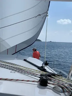 Man sailing on a 2020 Leopard 40 catamaran in open water.
