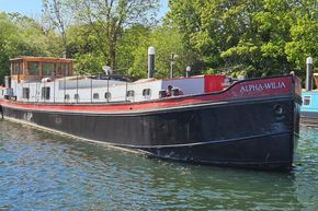 Luxemotor Dutch barge from 1926, named Alpha-Wilja, moored on a sunny day.