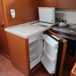 Beneteau Oceanis 51.1 2018 yacht kitchen with open fridge and stove.