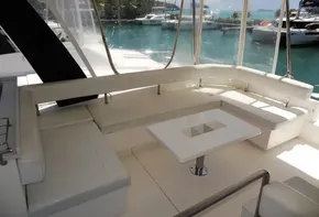 2017 Leopard 43 Powercat yacht with spacious seating area and table, docked at marina.