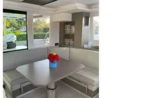 Interior of 2022 Leopard 42 yacht with dining area and floral centerpiece.