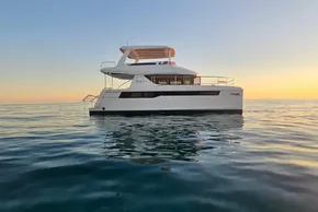 2024 Leopard 40 Powercat yacht on calm ocean at sunset.