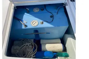 Storage compartment of 2022 Leopard 45 yacht with blue tank and marine equipment.