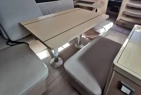 Interior of 2020 Beneteau Oceanis 46.1 yacht with modern seating and table.