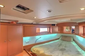 Luxurious cabin interior of 2013 Beneteau Oceanis 41 sailboat with cozy bed and wooden finish.