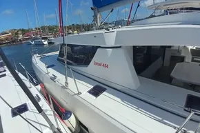 2022 Leopard 45 catamaran docked in a marina under clear blue skies.