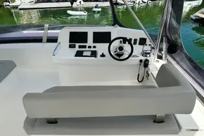 Helm of 2022 Leopard 53 Powercat with modern controls and seating, docked by the water.