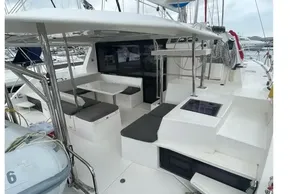 2020 Leopard 40 catamaran interior with seating area and table, docked at marina.