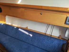 Starboard saloon seating with fold-up seat back to reveal a comfortable berrth
