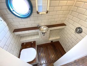 The washroom features a rain shower and dry toilet