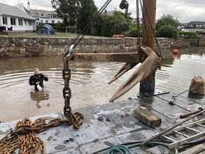 Crane lifting a large anchor. 