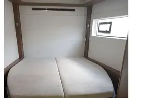 2020 Lagoon 46 yacht cabin with bed and window.