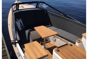 2026 Enkhuizensloep 680 Tender boat with wooden deck, docked by a serene lake.