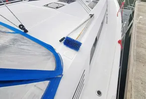 2020 Beneteau Oceanis 46.1 sailboat docked in marina, featuring sleek deck design.