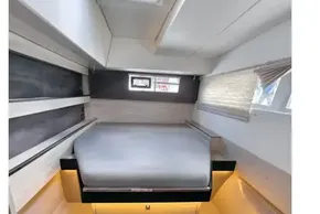 Modern cabin interior of 2020 Leopard 50 yacht with cozy bed and ambient lighting.