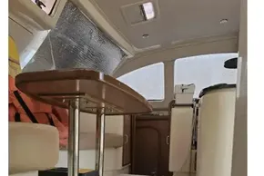 Interior of a 2008 Leopard 38 catamaran, featuring a wooden table and seating area.