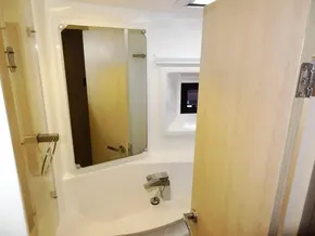 2015 Leopard 51 Powercat bathroom with mirror, sink, and wooden door.