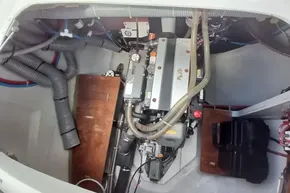 Engine compartment of a 2020 Lagoon 46 catamaran, featuring hoses and mechanical components.