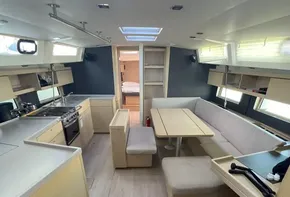 Spacious interior of 2020 Beneteau Oceanis 46.1 yacht with modern kitchen and dining area.