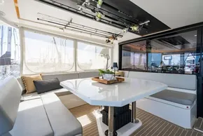 Luxurious Leopard 50 yacht interior with dining area, fishing rods, and panoramic windows, 2022 model.