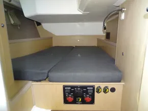 Interior cabin of 2017 Beneteau Oceanis 45 yacht with twin beds and control panel.