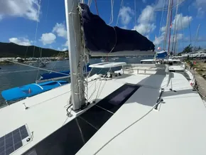 2020 Leopard 50 catamaran docked, featuring spacious deck and sails, under clear blue sky.