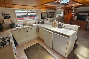 Luxemotor Dutch Barge 1926 kitchen interior with modern appliances and natural light.