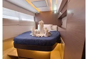Luxurious cabin interior of 2021 Leopard 50 yacht with elegant bedding and ambient lighting.