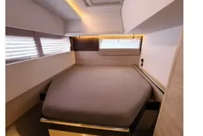 Modern cabin interior of 2020 Leopard 45 yacht with cozy bed and ambient lighting.