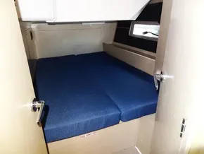 2020 Beneteau Oceanis 46.1 cabin interior with blue bedding and wooden finish.