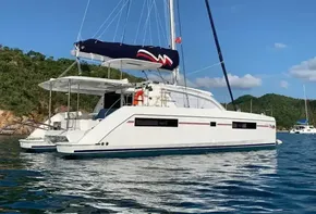2020 Leopard 40 catamaran sailing on calm waters with scenic background.