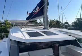 2021 Leopard 45 catamaran with solar panels and sleek design, docked in a sunny marina.